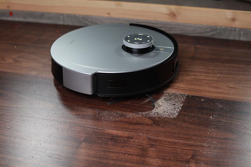 Ecovacs Deebot X1 Omni removes sand from a hard floor during a suction test